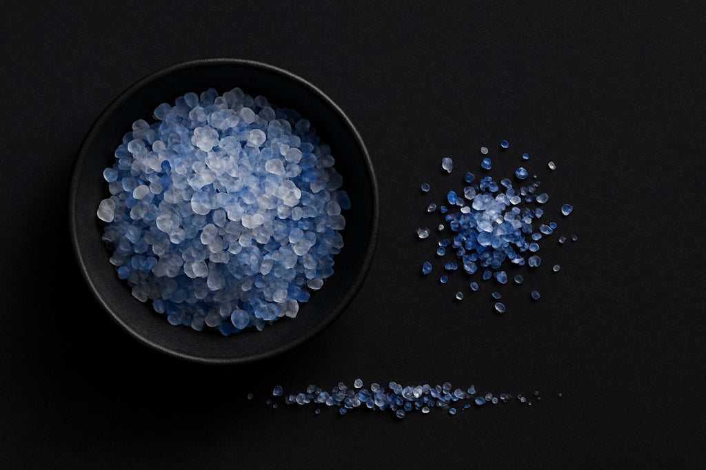 Persian blue salt crystals in black bowl on dark background